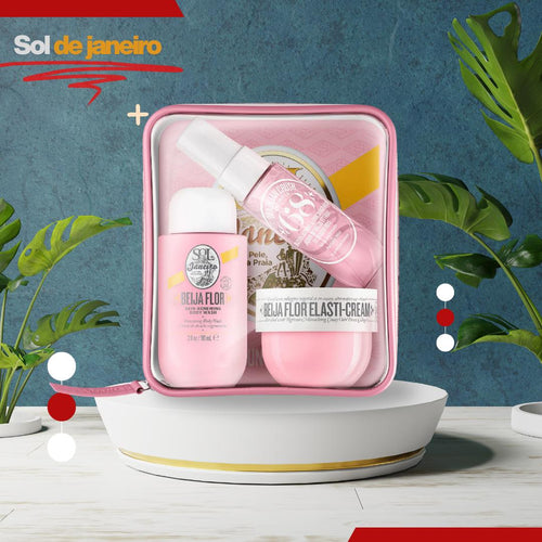 Pink skincare product set with 'Sol de Janeiro' branding on a blue background with green leaves.